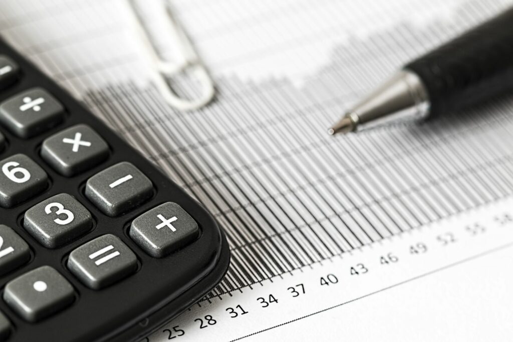 Calculatrice, graphique financier et stylo illustrant l’analyse d’un avis d’impôt 2026