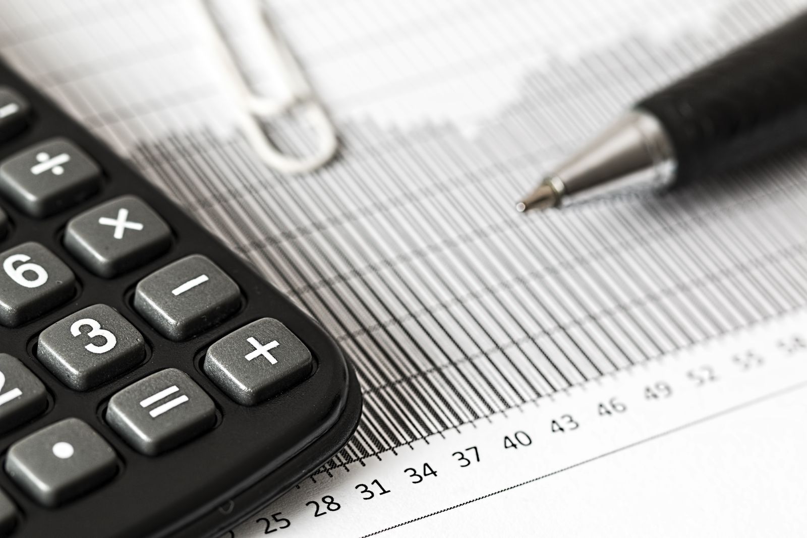 Calculatrice, graphique financier et stylo illustrant l’analyse d’un avis d’impôt 2026